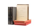 three books are stacked on top of each other on a white surface