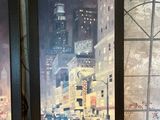 deux photos encadrées représentant un paysage urbain, posées sur une table