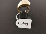 a close up of a gold ring with a tag on it