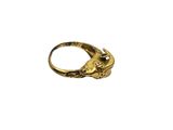 a close up of a gold ring on a white background
