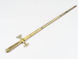 an old brass sword with a wooden handle on a white surface
