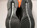 a close up of a pair of black and orange shoes