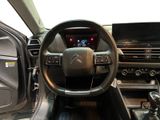 the interior of a car with a steering wheel and dashboard controls
