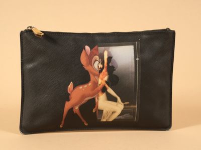 a close up of a purse with a picture of a deer on it