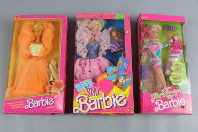 three barbie dolls are lined up in a row on a table