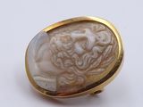 an image of a gold ring with a carved face of a man