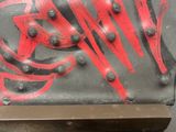 a red and black piece of art on a black surface