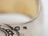 close up of a silver ring with a diamond in the center