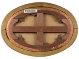 a picture of a round wooden window with a sticker on it