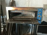 a small oven sitting on top of a table in a room