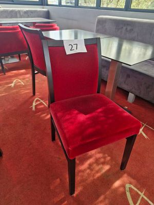red chairs and a table in a room with a red carpet
