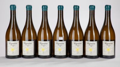 six bottles of wine are lined up in a row on a white surface