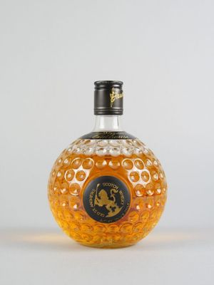 gros plan d'une bouteille d'alcool sur une surface blanche