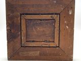 an old wooden picture frame with a hole in the middle