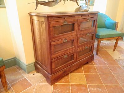 a dresser with a mirror on top of it in a room