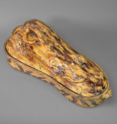 a close up of a wooden object on a gray surface