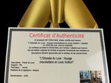 a gold statue with a certificate on it