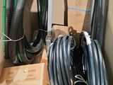 many hoses that are sitting on the floor next to a box