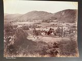 a black and white photo of a small town in the mountains