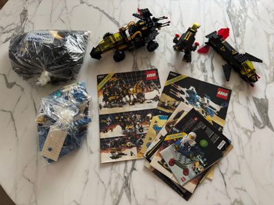 a bunch of legos sitting on a table next to a ball of yarn