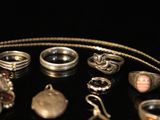 many different types of jewelry on a black surface