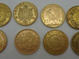 six different types of gold coins on a white surface