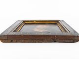 an old wooden tray with a picture of a man on it
