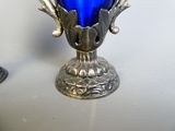 a blue glass vase sitting on top of a table