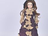 a figurine of a woman in a purple dress