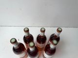 several bottles of wine are lined up on a white surface