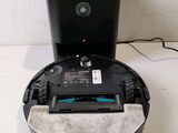 an image of a robotic vacuum cleaner sitting on top of a white floor