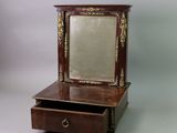 a small wooden dresser with a mirror on top of it