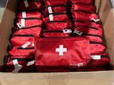many bags of medical supplies in a cardboard box
