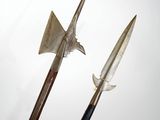 pair of old weapons on display against a white background
