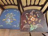 two chairs that have been painted with flowers on them