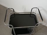 a black and chrome serving cart with a glass top