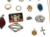 many different types of jewelry on a white surface