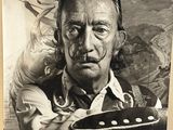 une vieille photo en noir et blanc d'un homme tenant une guitare