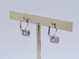 pair of silver and amethorate earrings on a metal stand