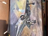 a book in a box with a picture of a fighter jet