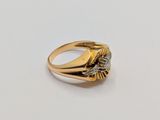 an image of a gold and diamond ring on a white surface
