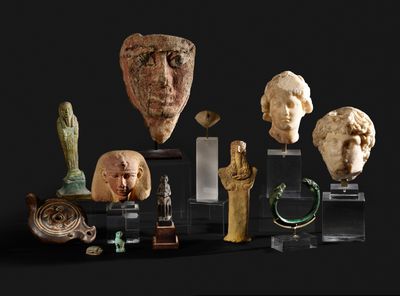 many pieces of art on display on a black surface