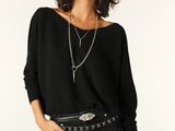 an image of a woman in a black top and black skirt