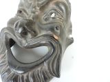 a close up of a mask on a white surface