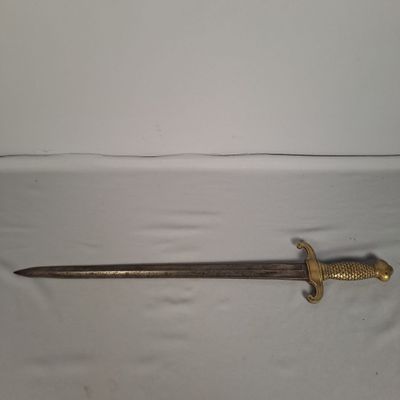gros plan d'une épée sur une table à fond blanc