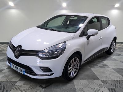 the white car is parked on a checkered tile floor