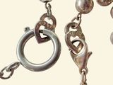 a close up of a chain with a ring on it