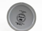 a white plate with a black and white logo on it