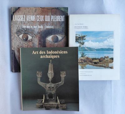 three books on a table with a blue cloth and a white sheet