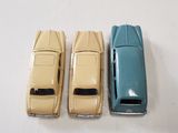 three toy cars sitting next to each other on a table